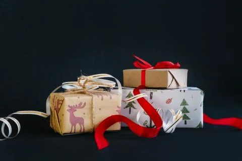Gift boxes Packed in wrapping paper and tied with ribbons for the new year or Stock Photos