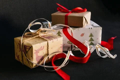 Gift boxes Packed in wrapping paper and tied with ribbons for the new year or Stock Photos