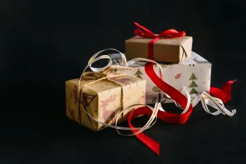 Gift boxes Packed in wrapping paper and tied with ribbons for the new year or Stock Photos