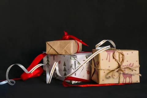 Gift boxes Packed in wrapping paper and tied with ribbons for the new year or Stock Photos