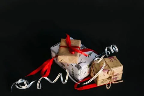 Gift boxes Packed in wrapping paper and tied with ribbons for the new year or Stock Photos