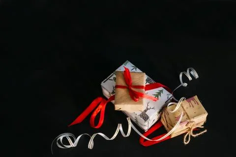 Gift boxes Packed in wrapping paper and tied with ribbons for the new year or Stock Photos