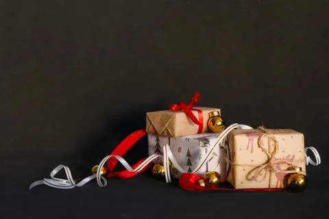 Gift boxes Packed in wrapping paper and tied with ribbons for the New year or Stock Photos