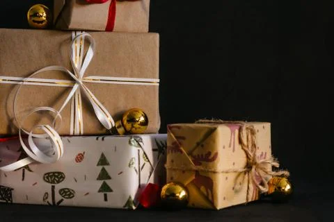Gift boxes Packed in wrapping paper and tied with ribbons for the New year or Stock Photos