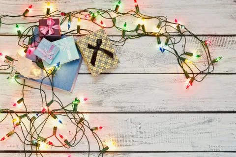 Gift boxes in a pile and a shiny garland, top view Stock Photos