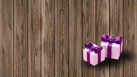 Gift boxes with pink and white wrapping and purple ribbons sit on a wooden plank Stock Photos