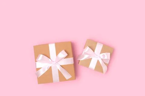 Gift boxes on a pink background. Present tied with ribbon. Stock Photos