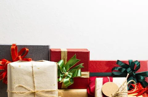 Gift boxes presents with ribbon on the table, white background. front view wi Stock Photos