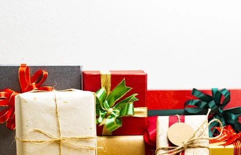 Gift boxes presents with ribbon on the table, white background. front view wi Stock Photos