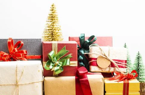 Gift boxes presents with ribbon on the table, white background. front view wi Stock Photos