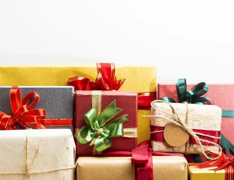 Gift boxes presents with ribbon on the table, white background. front view wi Stock Photos