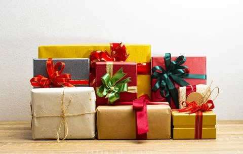 Gift boxes presents with ribbon on the table, white background. front view wi Stock Photos