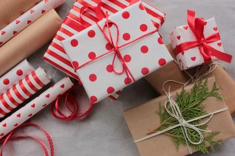 Gift boxes in red and white wrapping paper on table Stock-Fotos