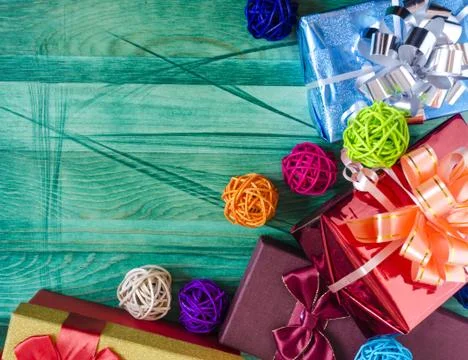 Gift boxes red blue colored decor on a green background Stock Photos