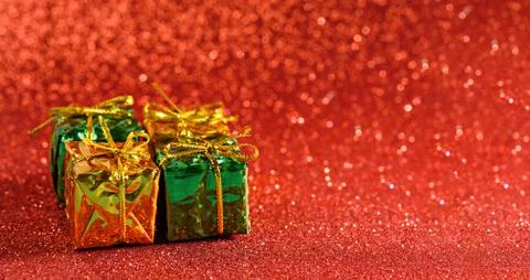 Gift boxes on red shiny background, copy space Stock Photos
