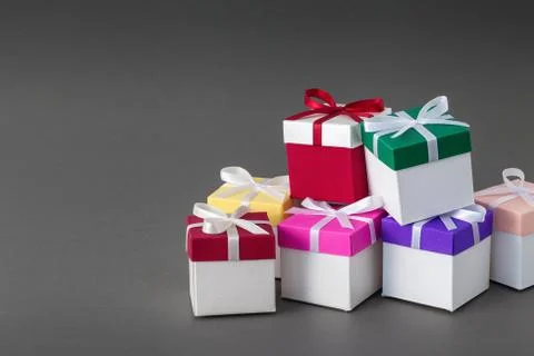 Gift boxes with ribbons on gray background. Copy space for text. Stock Photos