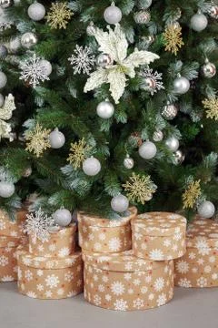 Gift boxes standing under a decorated Christmas tree Stock Photos