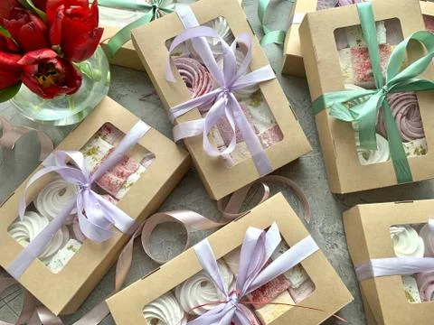 Gift boxes with sweets, with a bow of pastel colors. Stock Photos