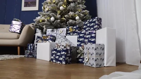 Gift boxes under the tree. Christmas presents. Gifts for the New Year. Stock Footage 166003891