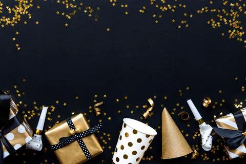Gift boxes in various gold pattern wrapping papers and party accessories ov.. Stock Photos