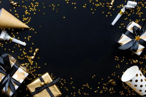 Gift boxes in various gold pattern wrapping papers and party accessories ov.. Stock Photos