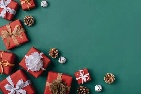 Gift boxes with white and brown bows on a green backdrop. Stock Photos