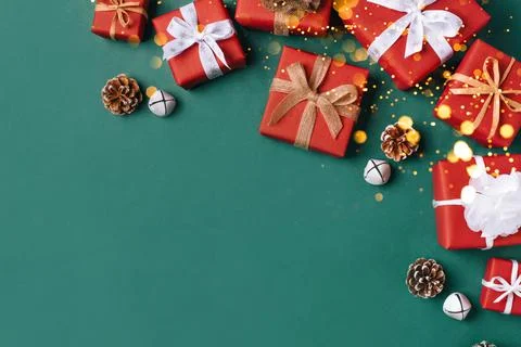 Gift boxes with white and brown bows on a green backdrop. Stock Photos