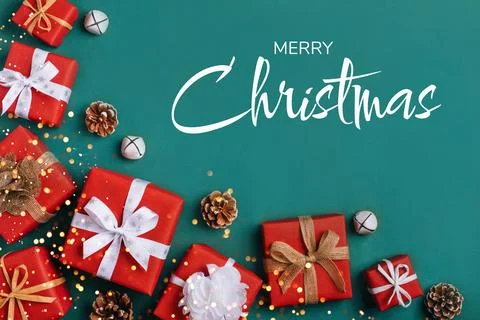 Gift boxes with white and brown bows on a green backdrop. Stock Photos