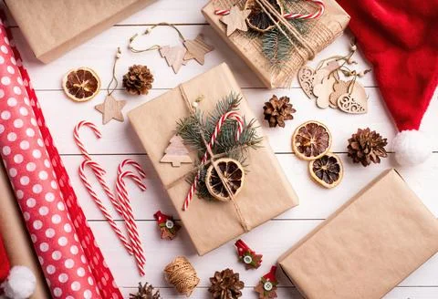 Gift boxes wrappaed in craft paper decorated with pine cones, candy canes a.. Stock-Fotos