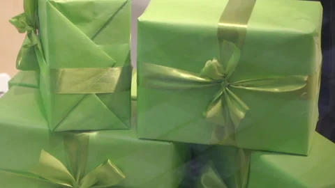 Gift boxes wrapped in green paper with ribbons. Stock Footage 335516172