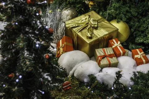 Gift boxes in wrapping paper under the Christmas tree Stock Photos