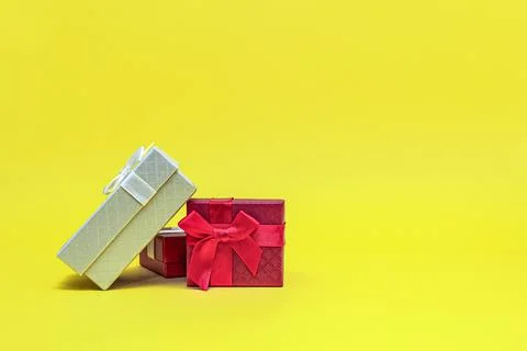 Gift boxes on a yellow background. Red gift boxes, open box. Postcard for pri Stock Photos
