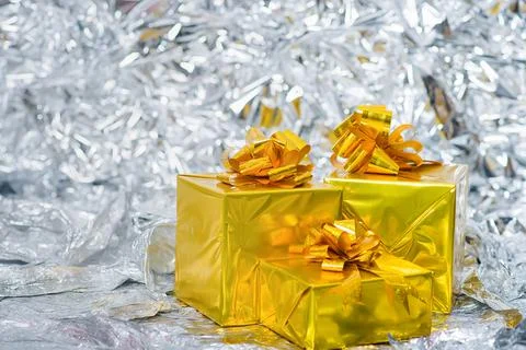 Gift boxs or present wrapped in gold paper. Holiday present. Stock Photos