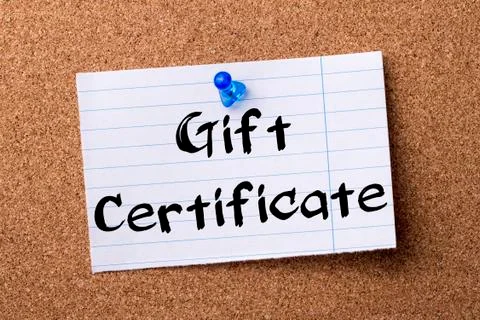 Gift Certificate - teared note paper pinned on bulletin board Stock Photos