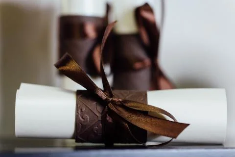 Gift Certificate , three close up of paper scroll with brown ribbon. Foto stock