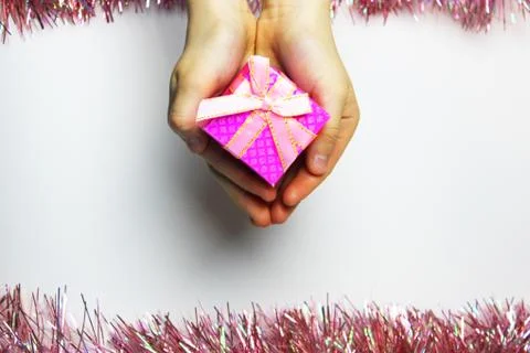 A gift in children's hands, on a white background, a girl gives gifts Stock Photos