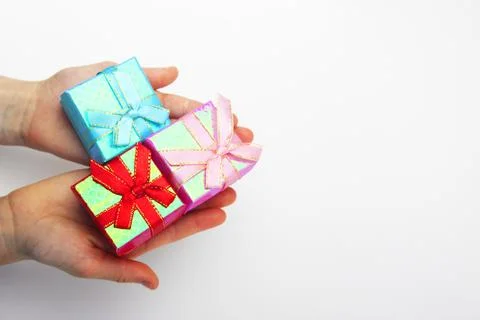 A gift in children's hands, on a white background, a girl gives gifts Stock Photos