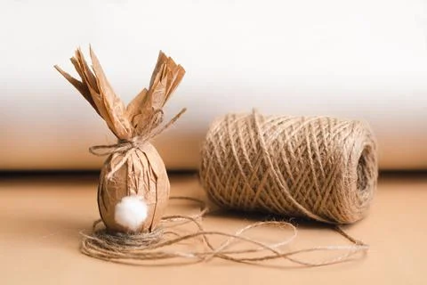 Gift Easter egg in brown craft paper in the shape of a rabbit Stock Photos