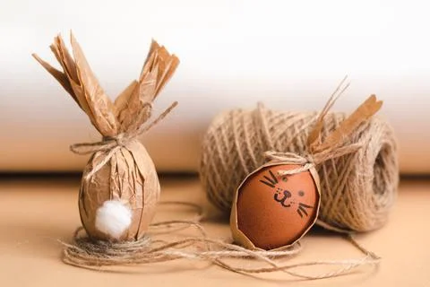 Gift Easter eggs in brown craft paper in the shape of a rabbit Stock Photos