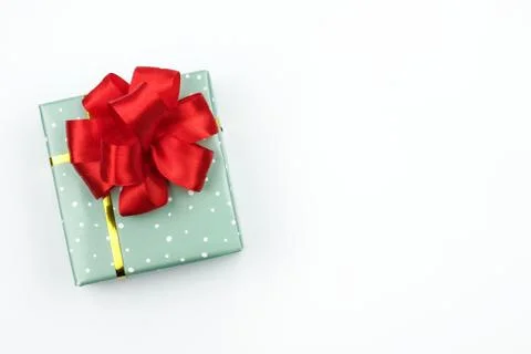 Gift in green packaging with a red bow Stock Photos