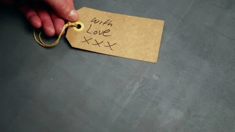 Gift with love tag on gray background Stock Footage 208425751