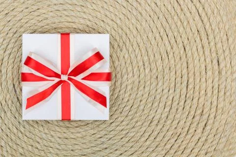 Gift lying on background made of rope Stock Photos