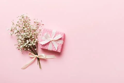 Gift or present box and flower gypsophila on light table top view. Greeting.. Stock Photos