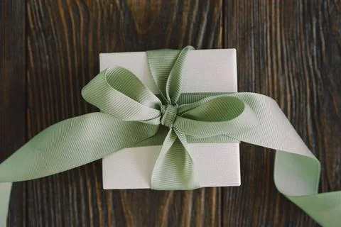 Gift or present box with green ribbon on wood background Stock Photos
