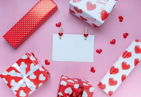 Gift or present box, mini heart and white greeting card on pink background. f Stock Photos