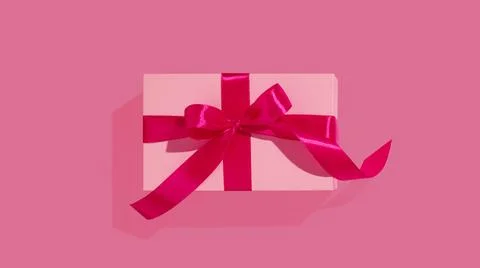 Gift or present box on pink background. Flat lay composition for birthday Stock Photos