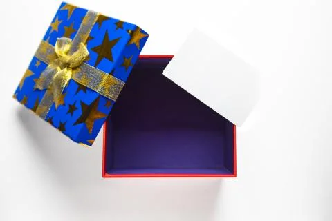 Gift or present empty box with golden ribbon and greeting card. Stock Photos