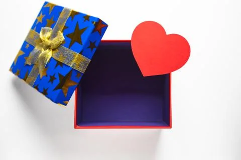 Gift or present empty box with golden ribbon and paper heart. Stock Photos