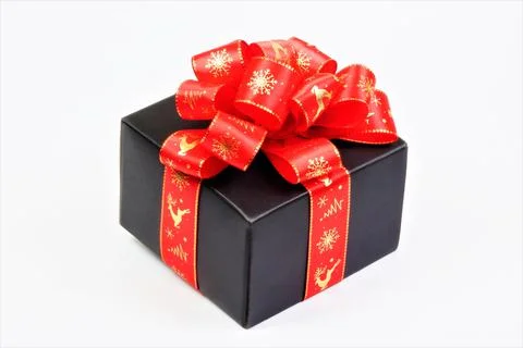 Gift package-a box with a red bow, isolated on a white background. Stock Photos