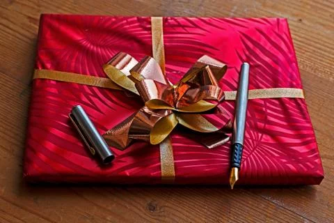 Gift package with open pen on it Stock Photos